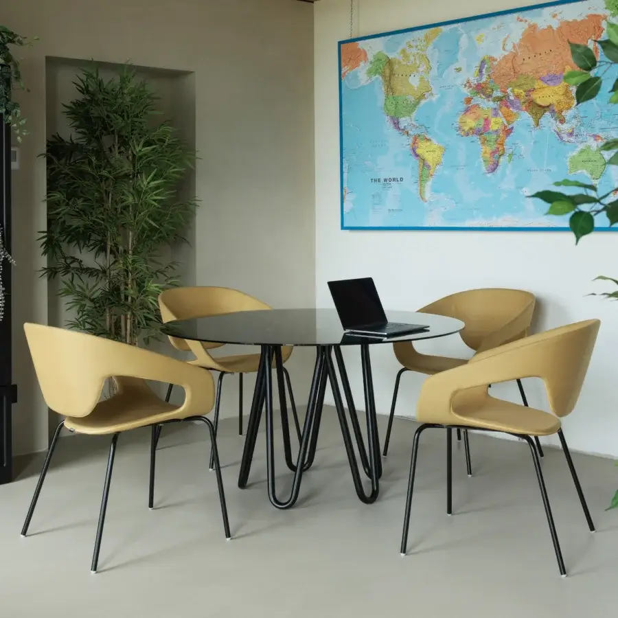 Elegant Casamania Vad armchair with muted yellow matt polypropylene seat and sleek black metal base