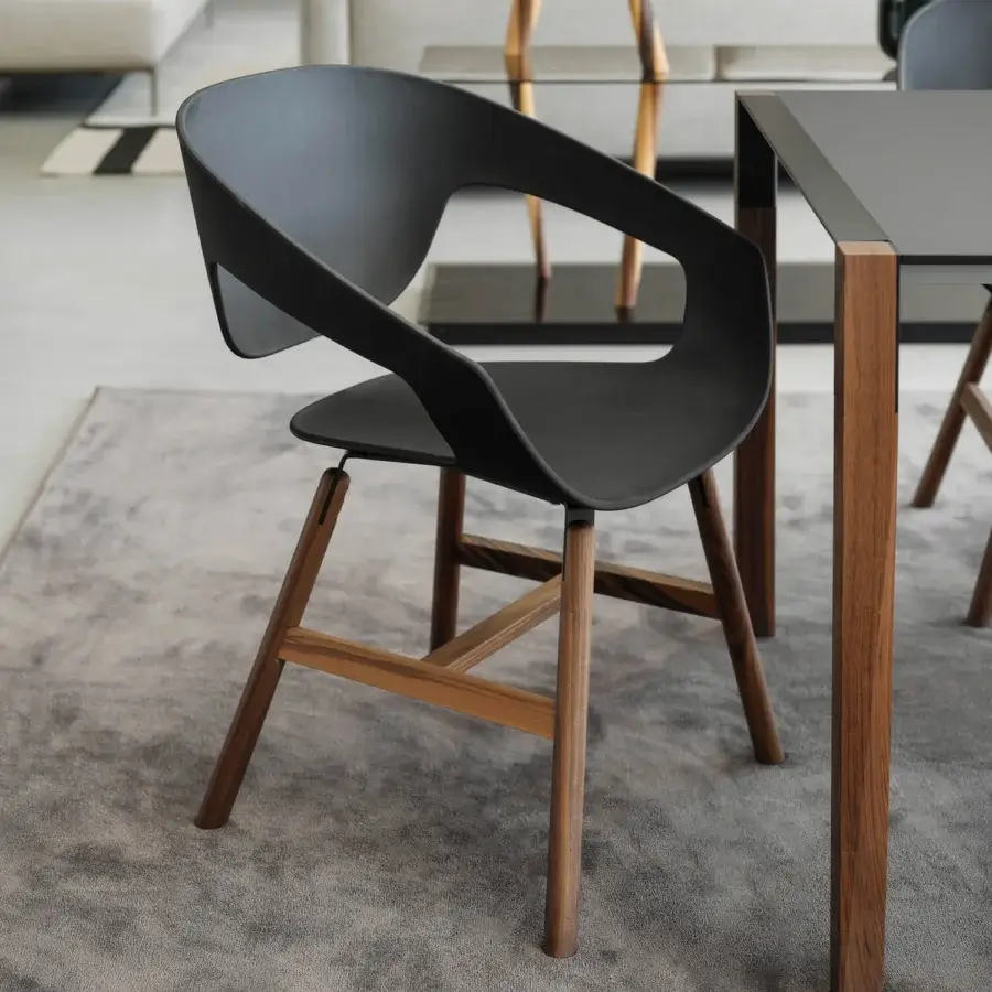 Exceptional Casamania Vad armchair with curved black reinforced polypropylene and a skilled wooden base with matte finish