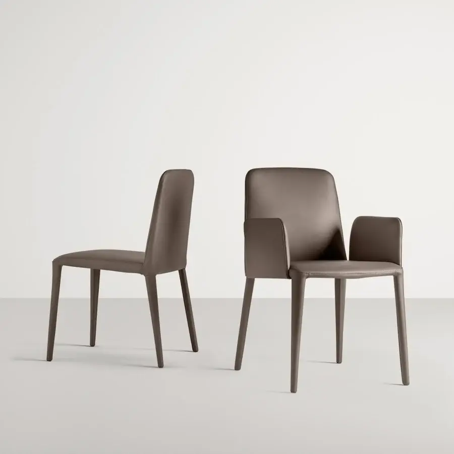Distinguished Frag Elf chair presents sleek lines with full dark brown leather upholstery and a flexible back built in Italy