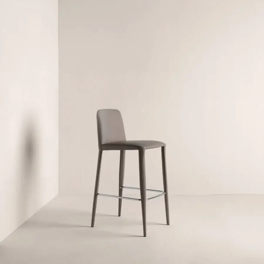 Elegant Gordon Guillaumier Frag Elf stool presents fully upholstered design with muted gray-brown finish and sleek metal support bar