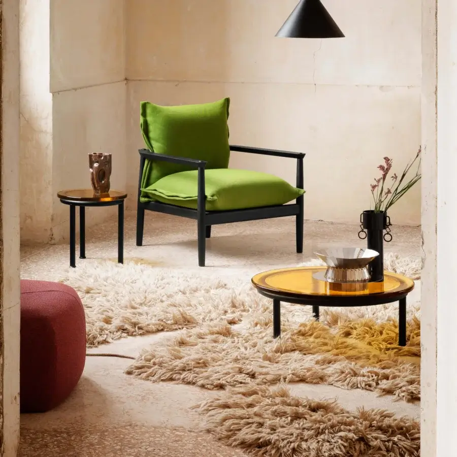 Distinguished Miniforms Zigo coffee table with rippling, golden-brown cast glass top and slender matte black legs