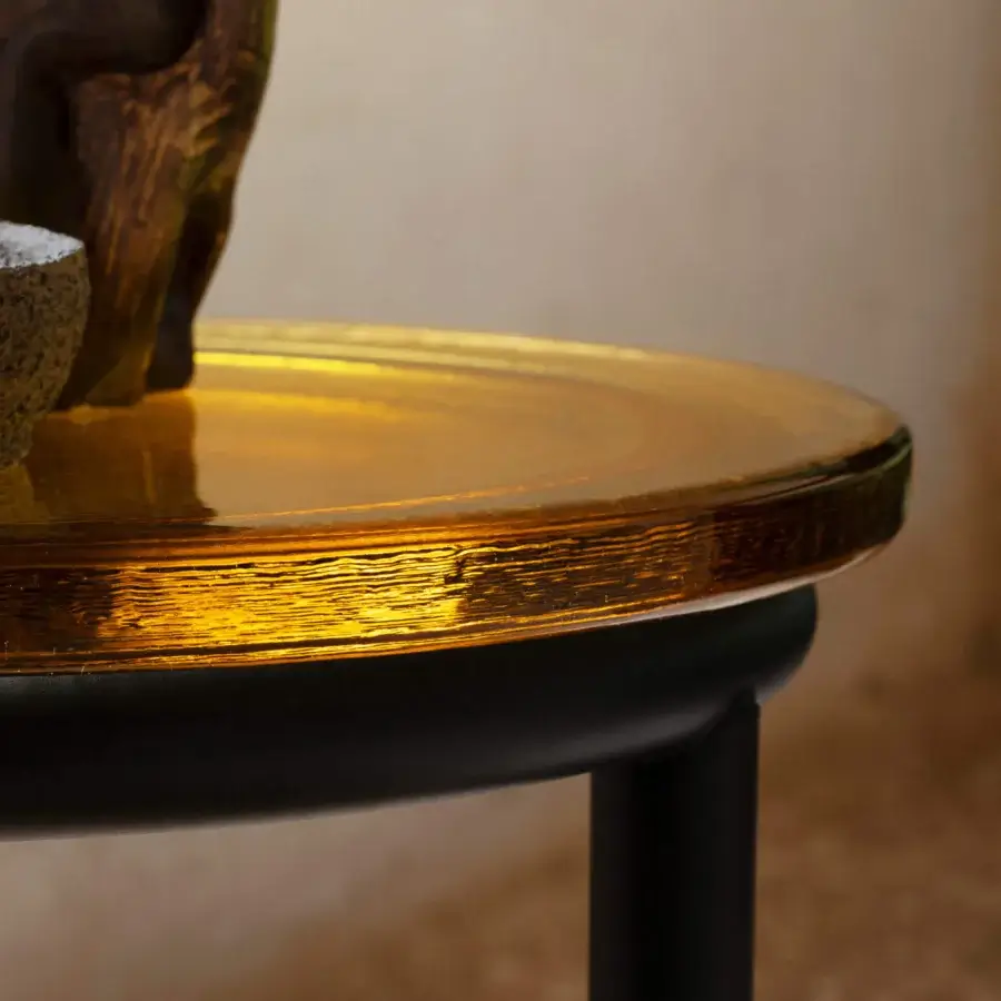 Distinguished Miniforms Zigo side table in amber cast glass with black tubular metal base and rippled surface