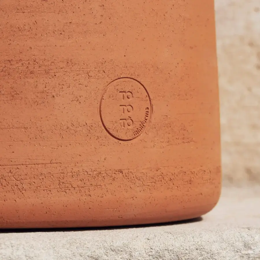 Superior Miniforms Tototò coffee table crafted from reddish-brown terracotta with a textured earthy finish
