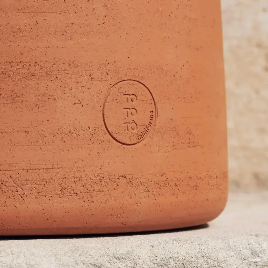 Superior Miniforms Tototò side table crafted from terracotta with an earthy reddish-brown tone and textured finish