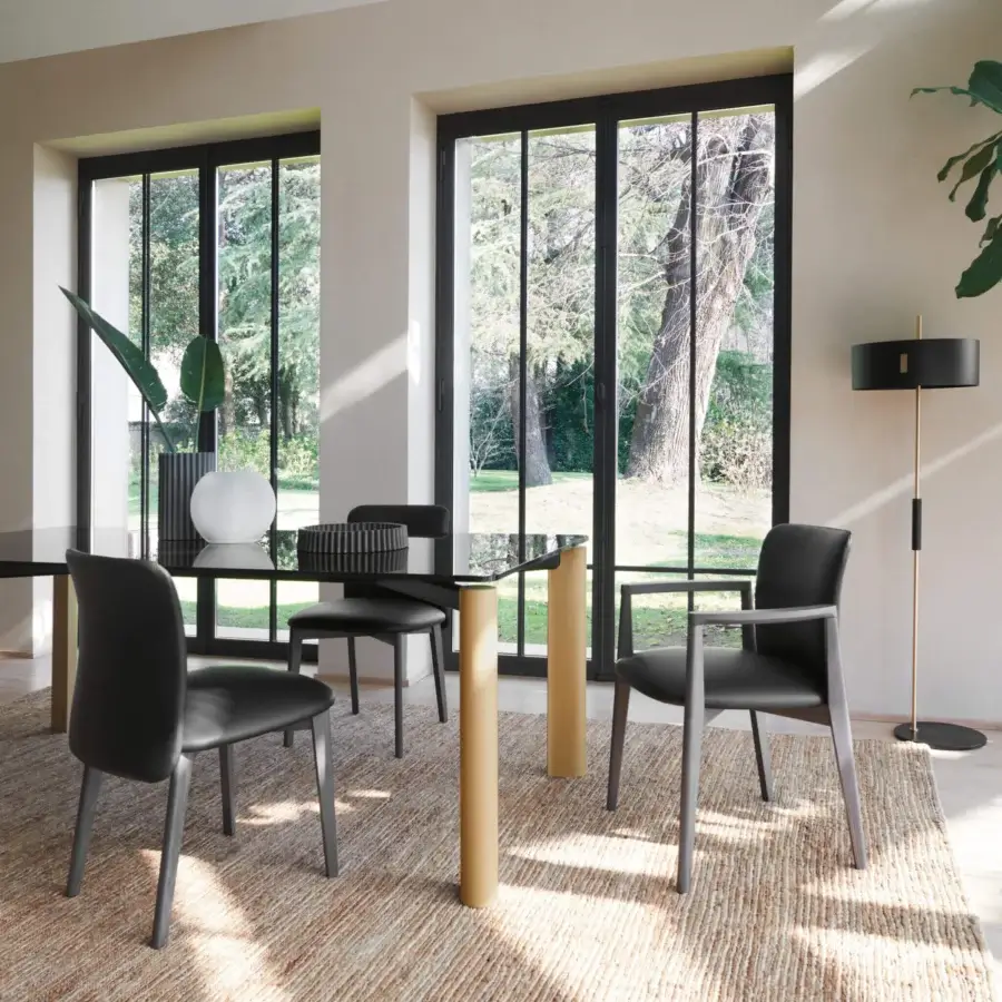 Distinguished Frag Siloe chair with black leather seat and dark gray intersecting legs exhibiting a graceful curved backrest and armrests