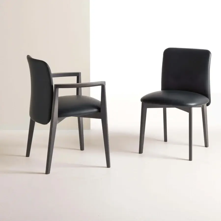 Superior Frag Siloe chair with dark upholstered seat and backrest, built with a smooth matte wood frame and graceful curving legs
