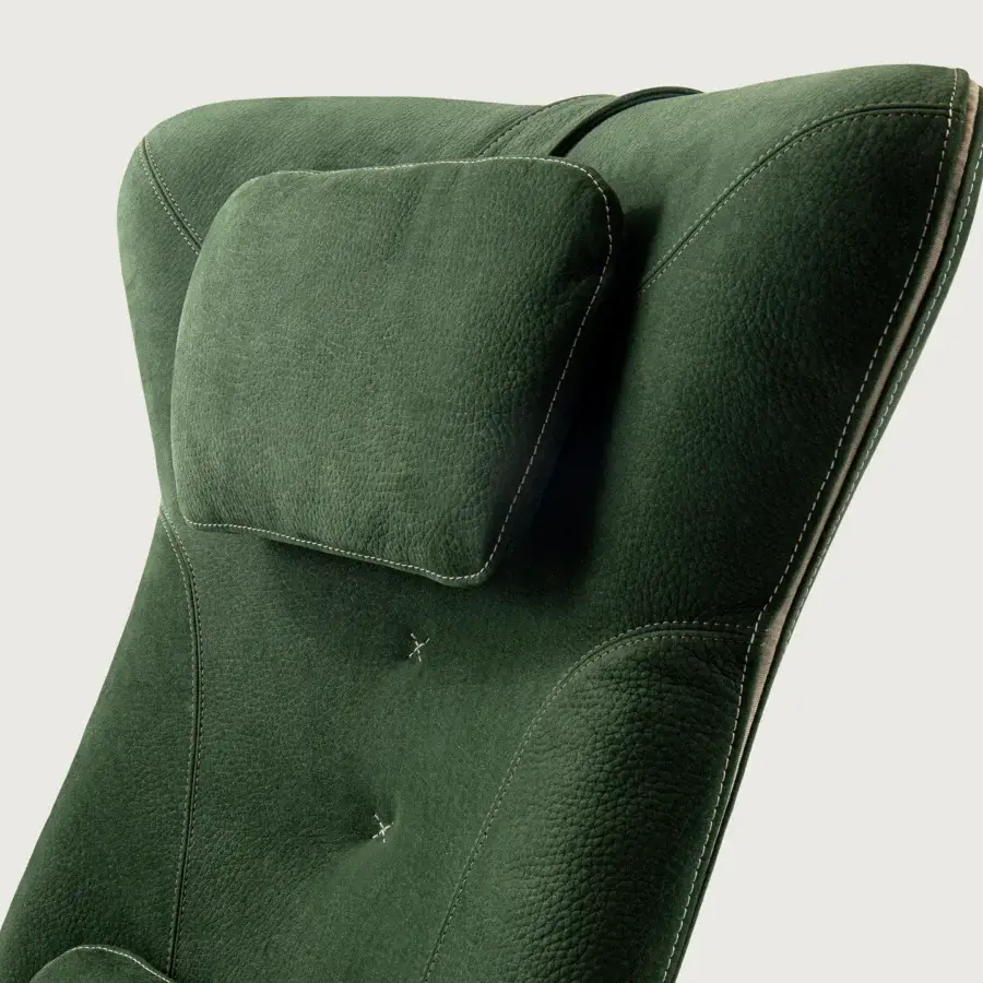 Superior Borzalino Mia lounge chair upholstered in textured dark green fabric or leather with meticulous white stitching and a lacquered metal base