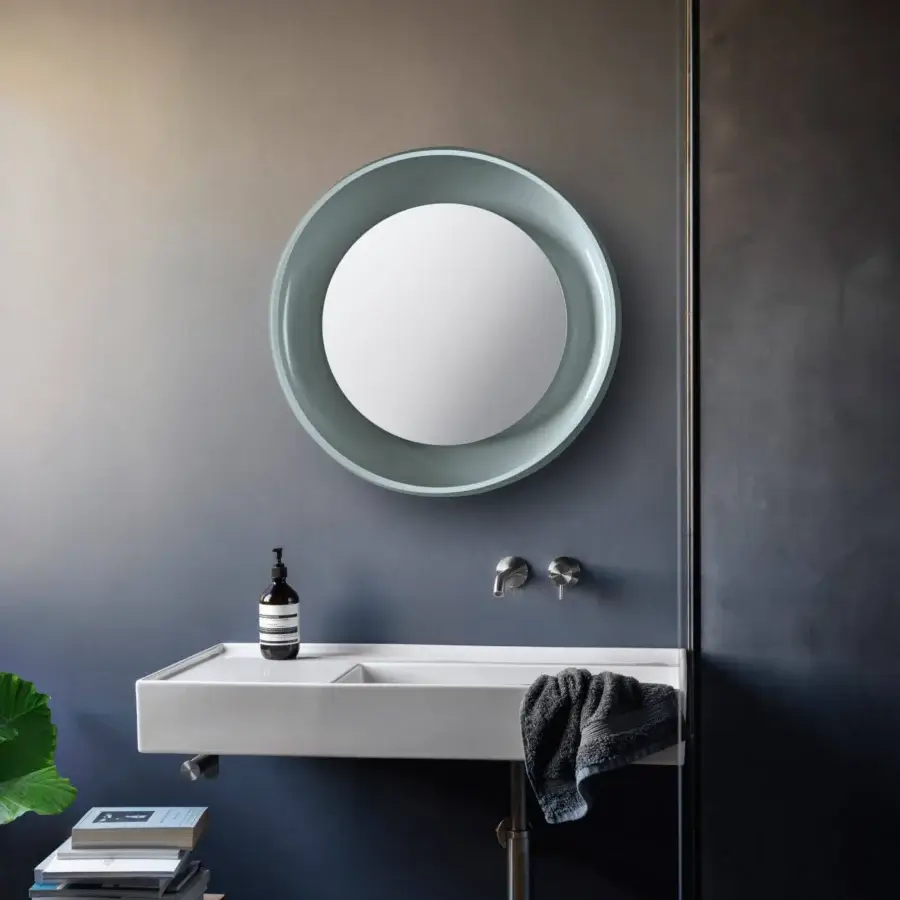 Distinguished Miniforms Coque mirror with a textured outer skin and shiny enamelled inner surface in light blue-green