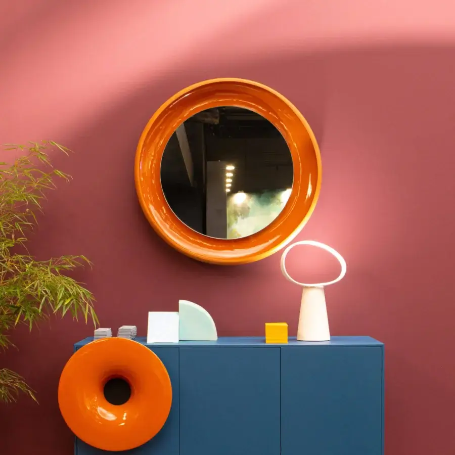 Elegant Miniforms Coque mirror with a dynamic contrast between textured glossy orange and shiny enamelled surfaces