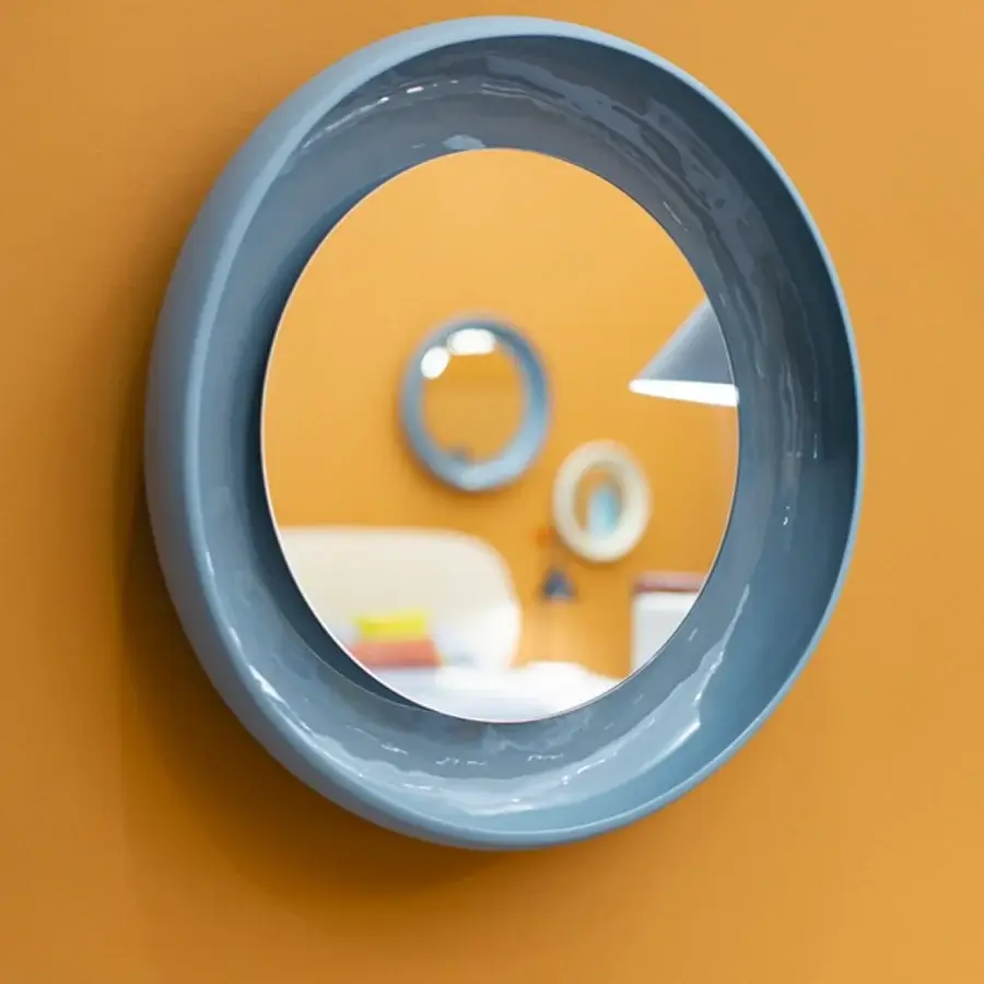Superior Miniforms Coque mirror with a dynamic contrast between textured outer skin and shiny inner surface in light blue-grey glossy sheen