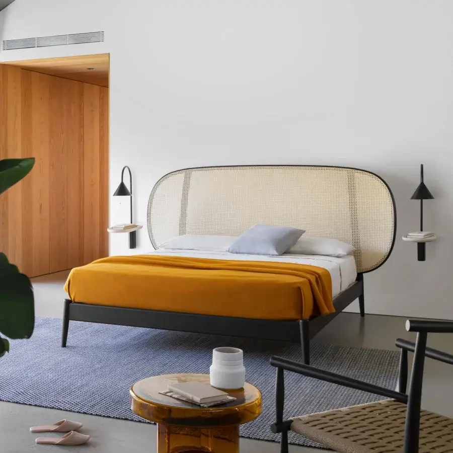Elegant Miniforms Shiko Wien bed crafted with wood and woven cane, featuring a matte black finish and rounded headboard