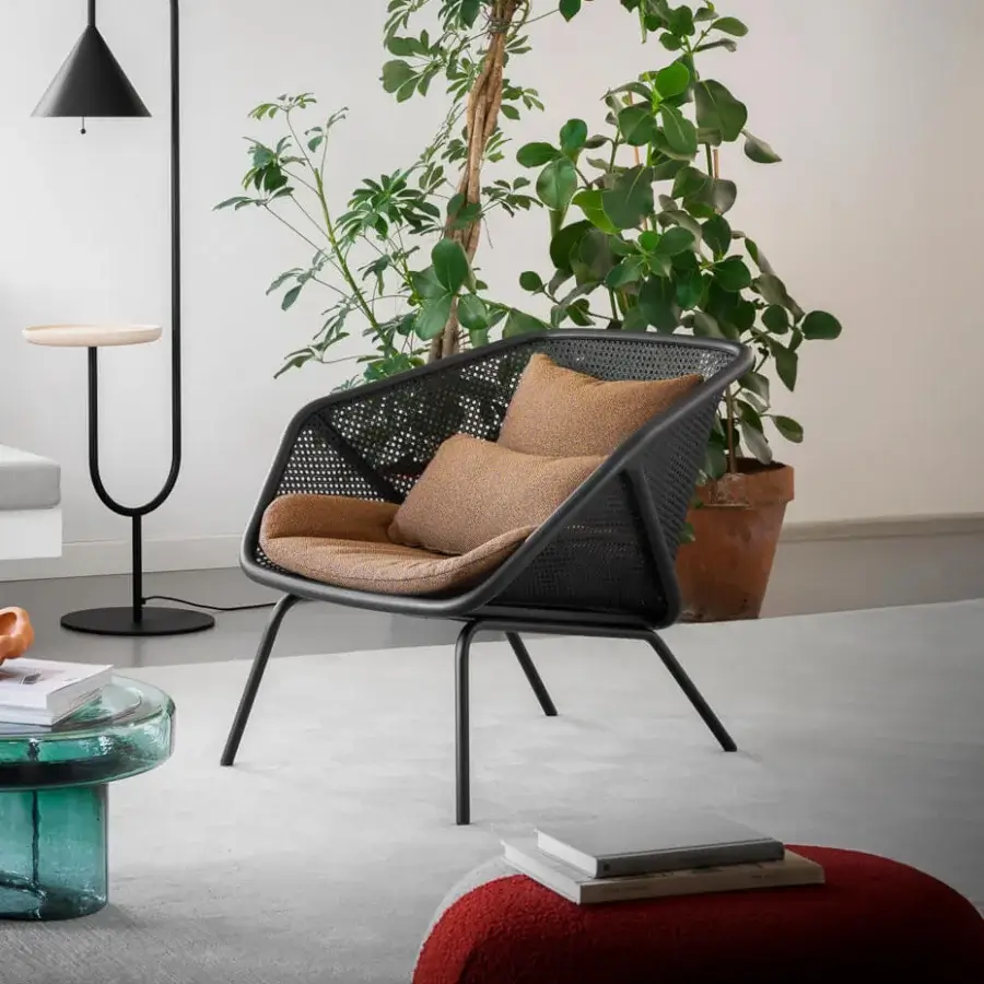 Superior Miniforms Colony lounge chair with enveloping structure and golden-brown textile cushions in woven Viennese straw and matte black metal