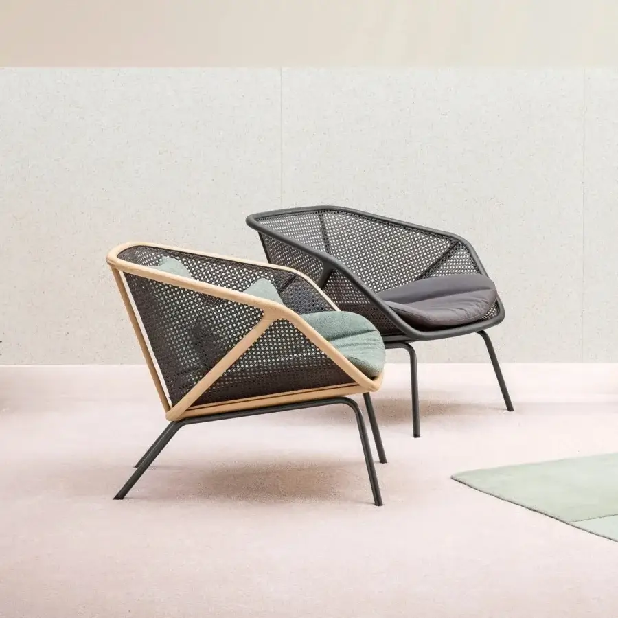 Distinguished Miniforms Colony lounge chair with enveloping woven Viennese straw and light-toned wood frame built with dark metal legs