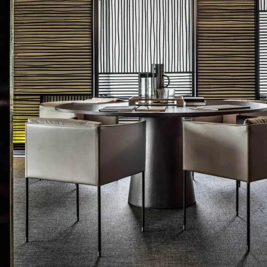 Superior Frag armchair upholstered in light grey textile with slender dark-finished metal legs crafted in Italy