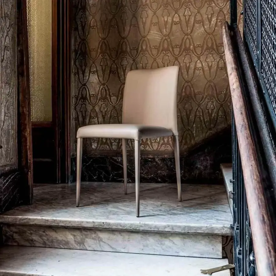 Elegant Bonaldo Deli chair with light beige leather upholstery and sleek painted metal legs exhibits a smooth finish