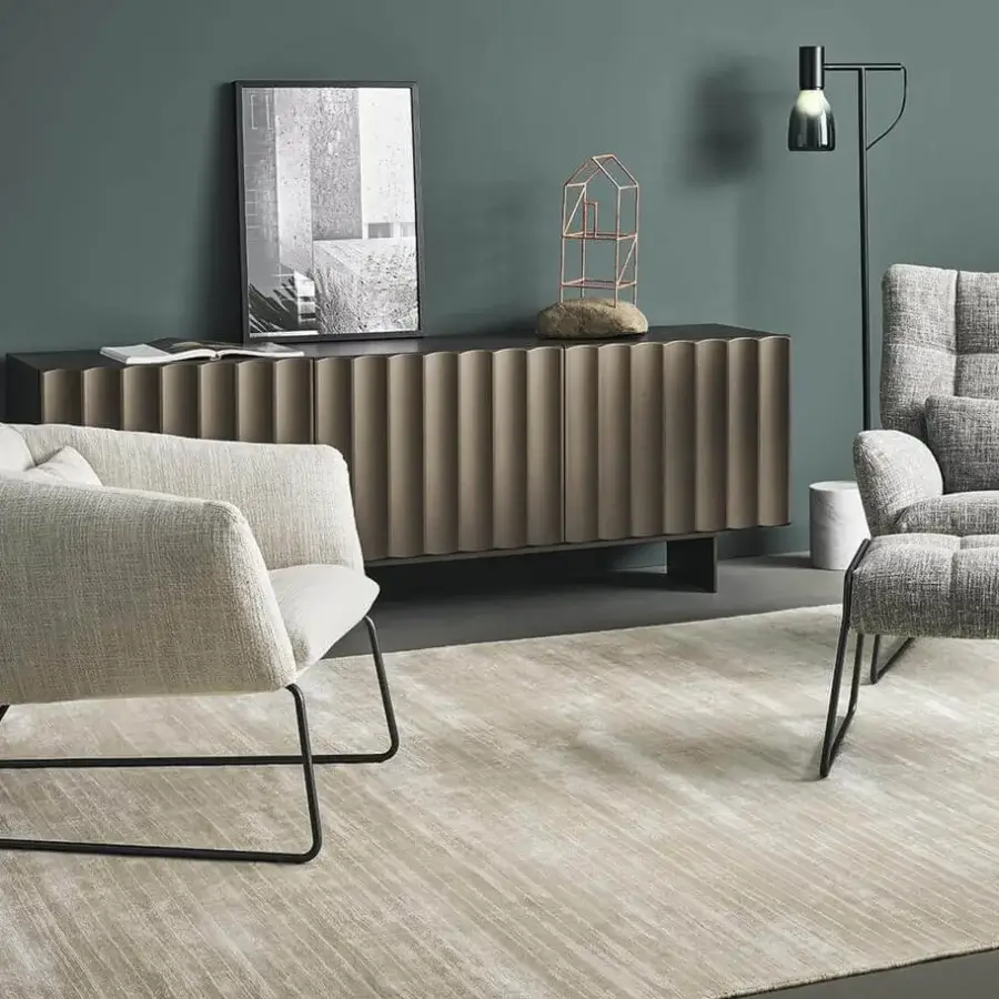 Exceptional Bonaldo Nikos lounge chair with a geometric silhouette and black painted metal sled base, upholstered in light beige textured fabric