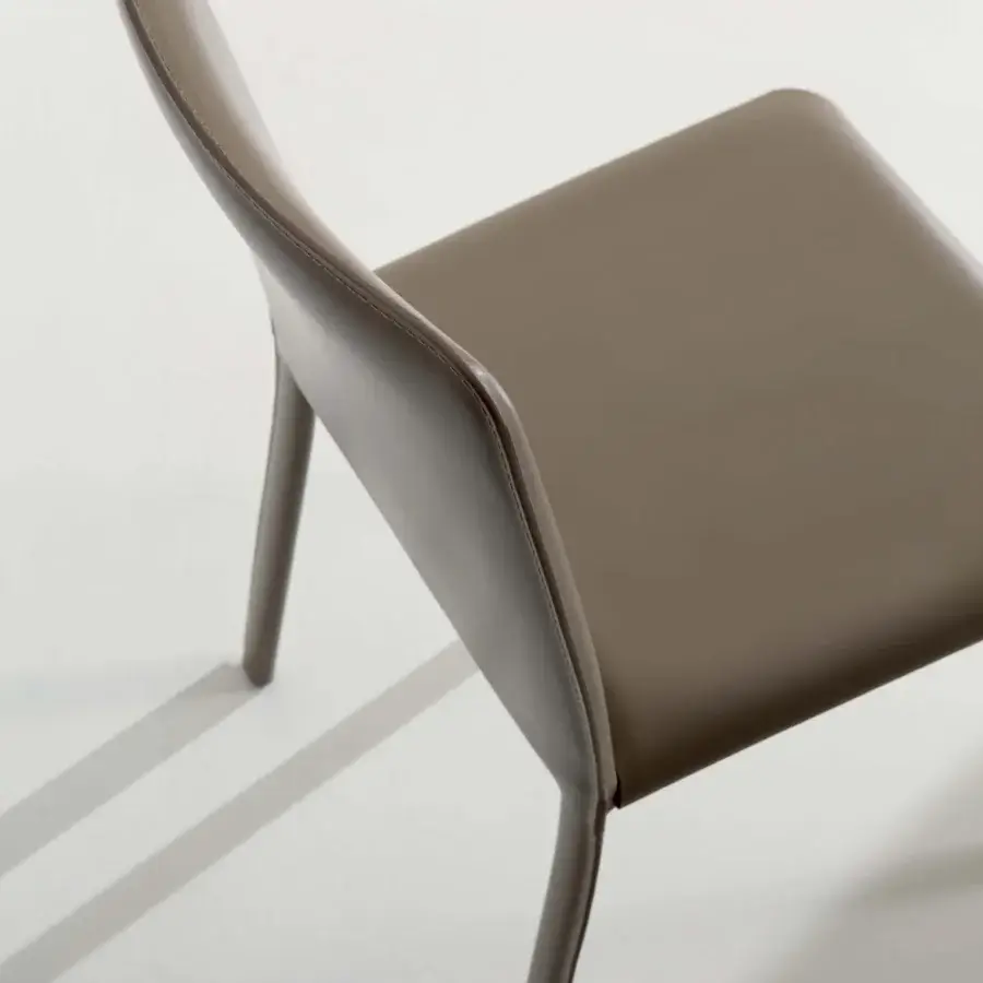 Sophisticated Ozzio Italia Lunette chair with curved lines and muted taupe faux leather upholstery crafted in Italy
