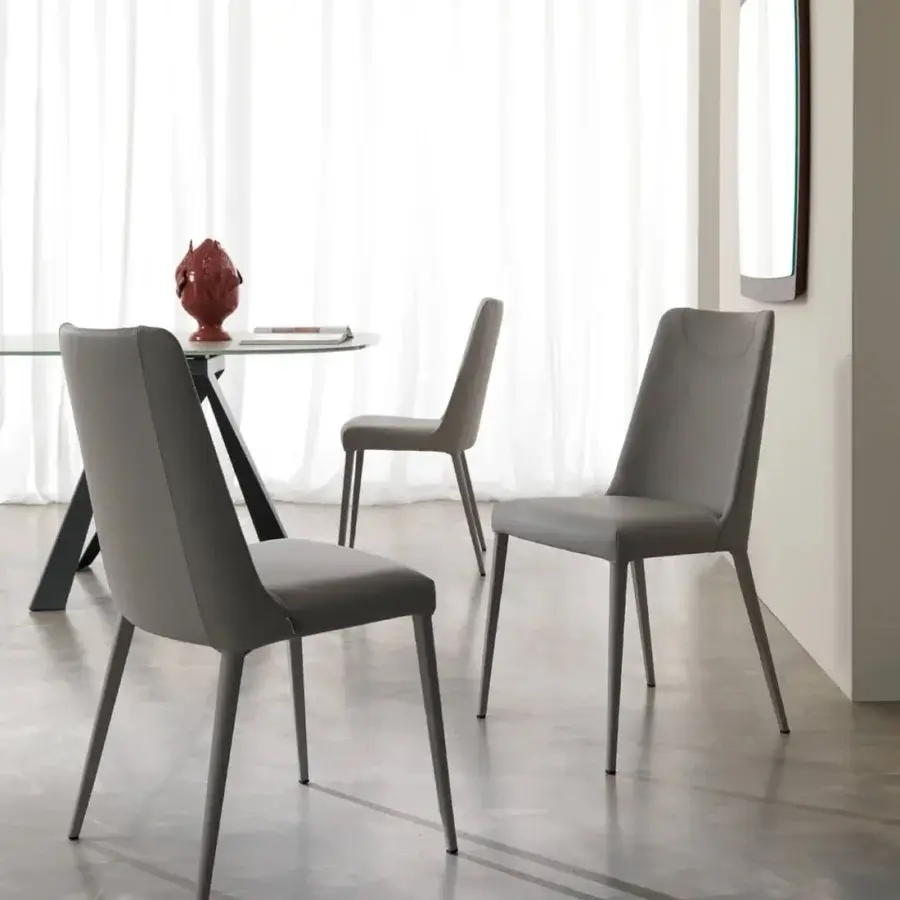 Elegant Ozzio Italia Sofia chair fully upholstered in light gray smooth matte material with fine stitching