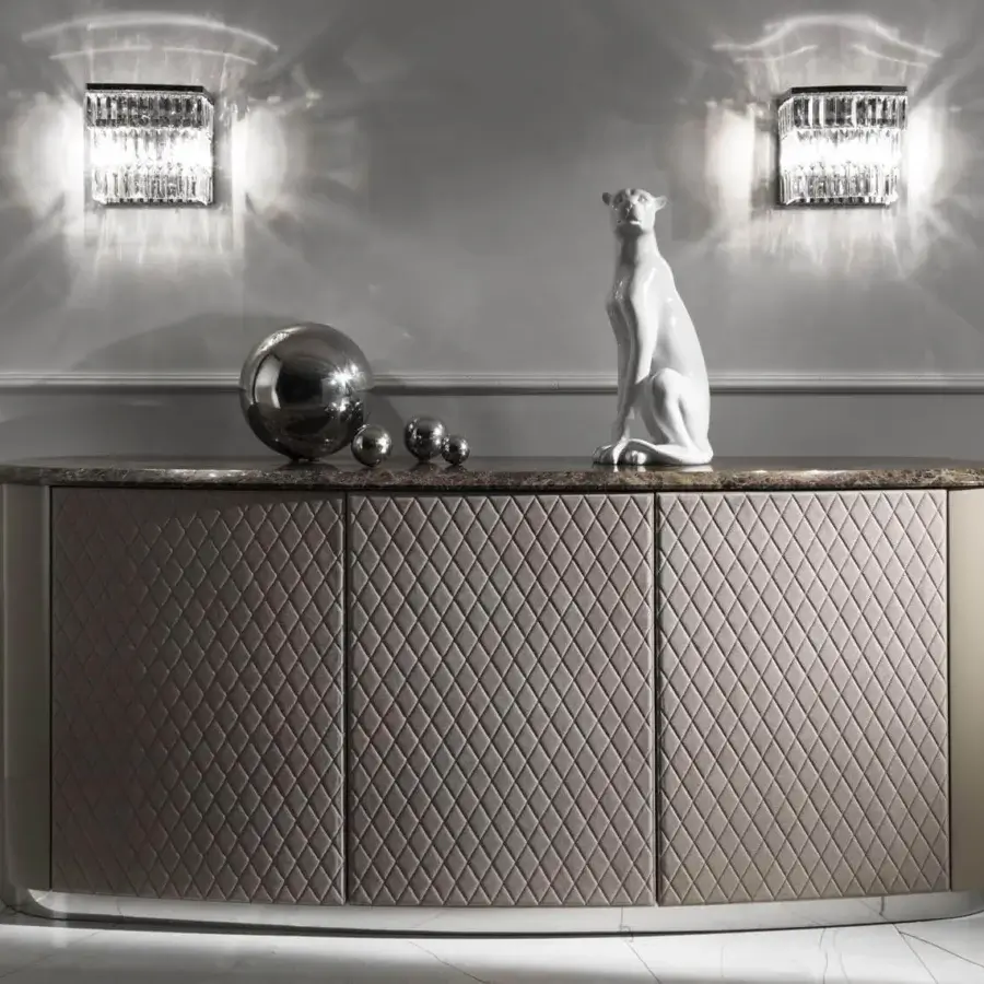 Elegant DV Home Collection Byron wall lamp with a geometric chrome structure and tiered bevelled glass pendants