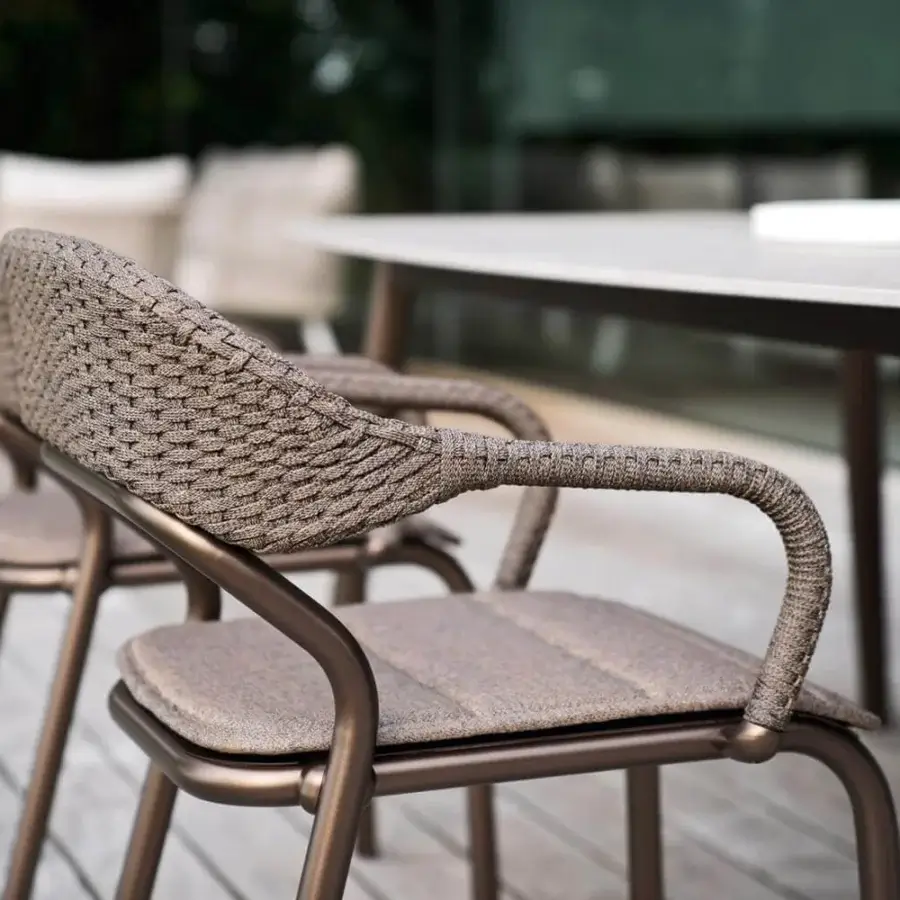 Distinguished Varaschin Noss armchair with a matte bronze aluminum structure and hand-woven light brown synthetic fiber rope back