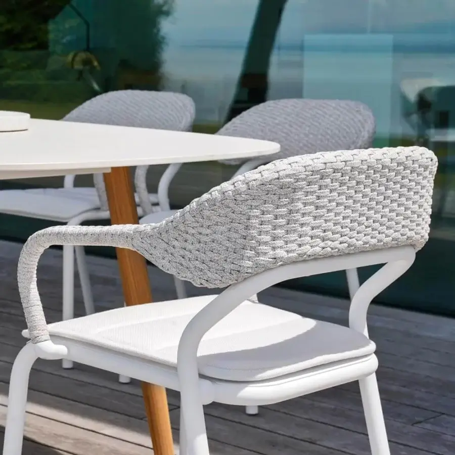 Harmonious Varaschin Noss armchair with a matte white aluminum frame and hand-woven polypropylene rope back, paired with a white seat cushion