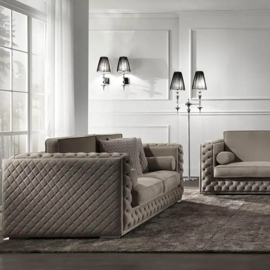 Lavish DV Home Collection sofa with taupe velvet upholstery, quilted detailing and a low chrome metal base