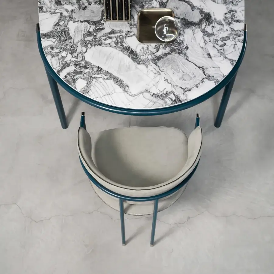 Innovative Cierre1972 Mac armchair with a teal metal frame and light gray upholstered seat trimmed in a darker band