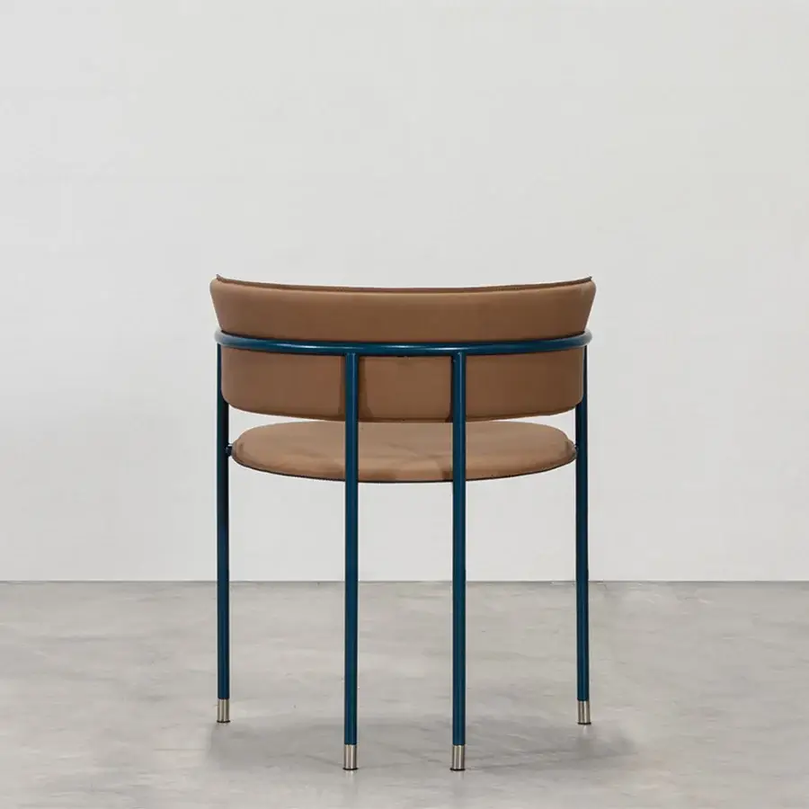 Distinguished Cierre1972 Mac armchair with a dark blue metal frame and tan leather upholstery crafted with sleek chrome accents