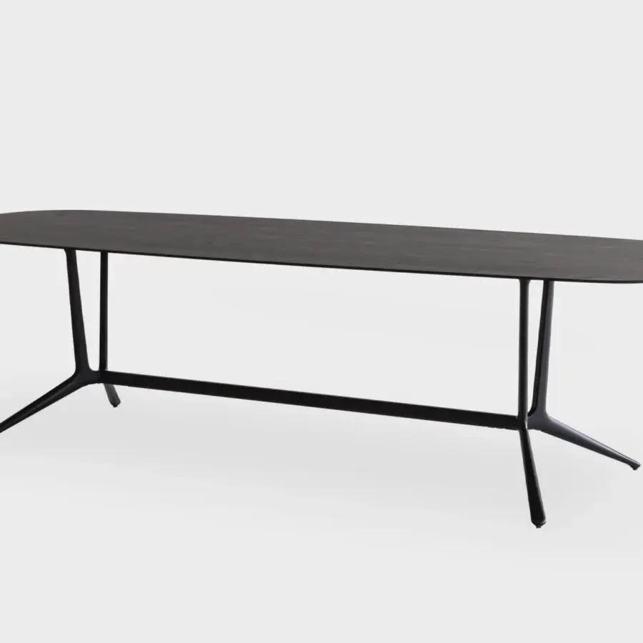 Elegant Lapalma Trail conference table with a dark, matte barrel-shaped steel top and zoomorphic black powder-coated aluminum base
