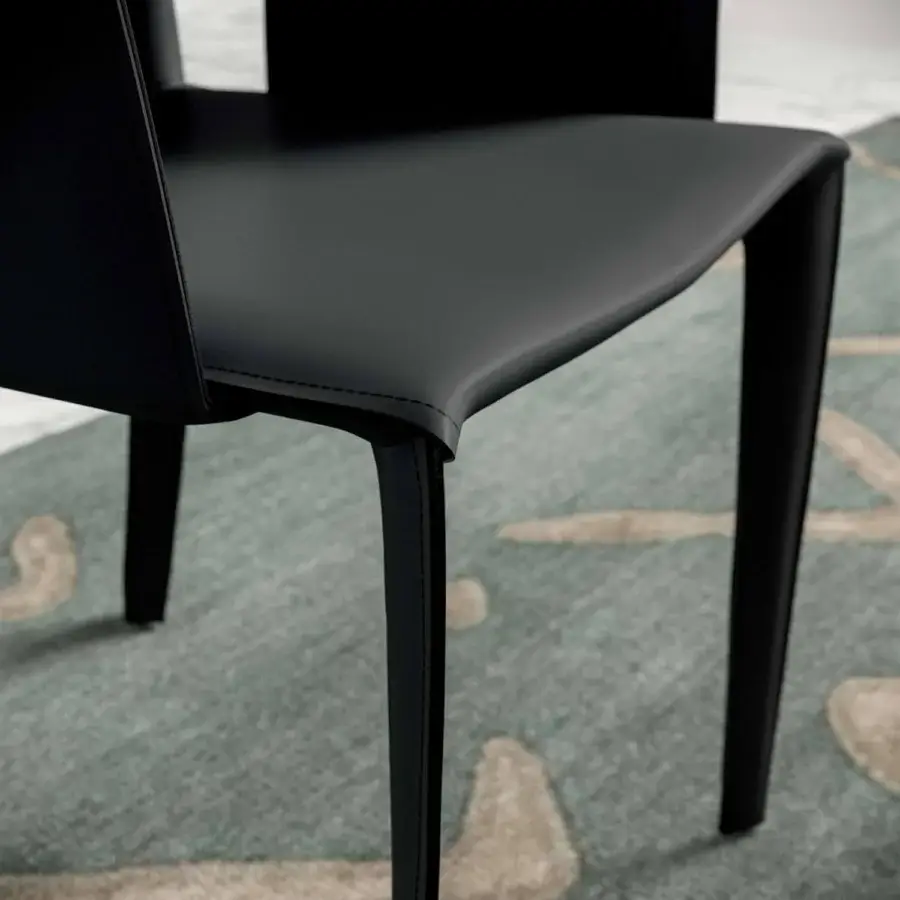 Avant-garde Ozzio Italia Frisbee chair with sleek black synthetic leather and curved proportional silhouette