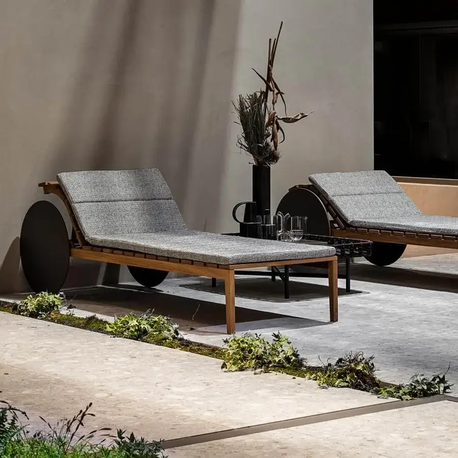 Superior Potocco Suno lounger built with Iroko wood slats and comfortable gray textured textile, finished in a light brown matte tone