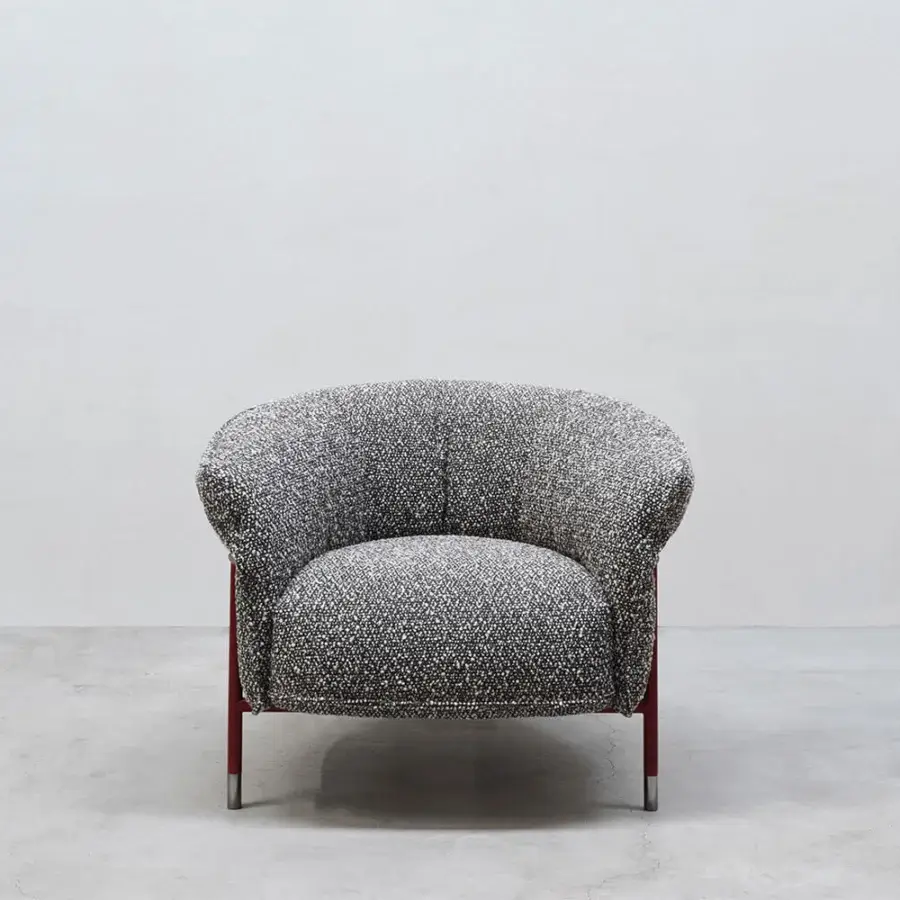 Sophisticated Cierre1972 Mac lounge chair with black and white speckled textile and reddish-brown metal frame