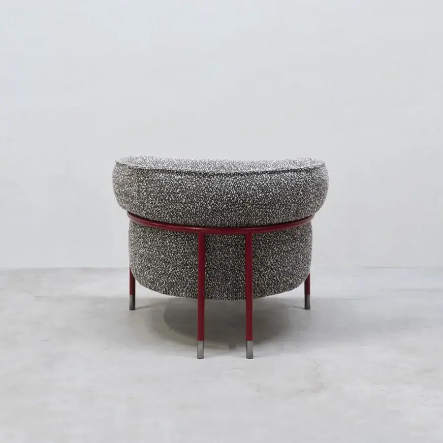 Sophisticated Cierre1972 Mac lounge chair combining speckled black and white textile with a red tubular metal frame