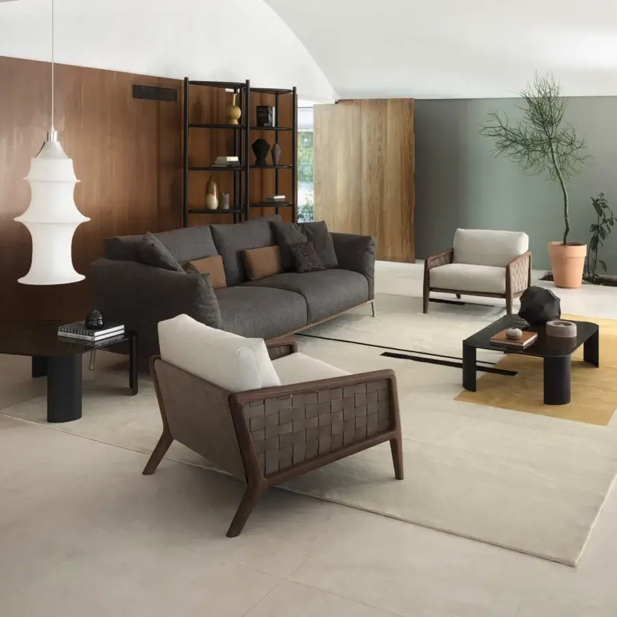 Distinguished Cierre1972 Iole lounge chair with hand-carved detailing in medium brown wood and supple brown leather with a light beige cushion