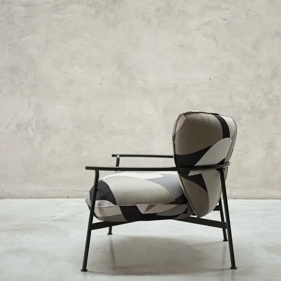 Exceptional Cierre1972 Gina lounge chair in intersecting gray, white, and black textile with a matte dark metal frame