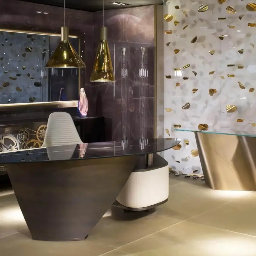 Elegant Reflex Vele desk with curved Marble glass and bronze finished metal base, built with a light cream cylindrical support