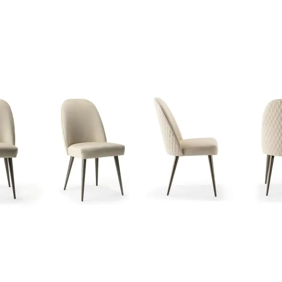 Superior Reflex Ludwig chair with light beige textile upholstery, quilted detailing and dark-toned metal legs with smooth matte finish