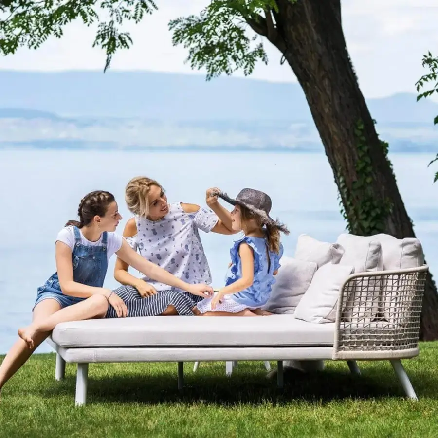 Elegant Varaschin Emma lounger with woven synthetic frame, plush cushions and sleek white-finished aluminum legs