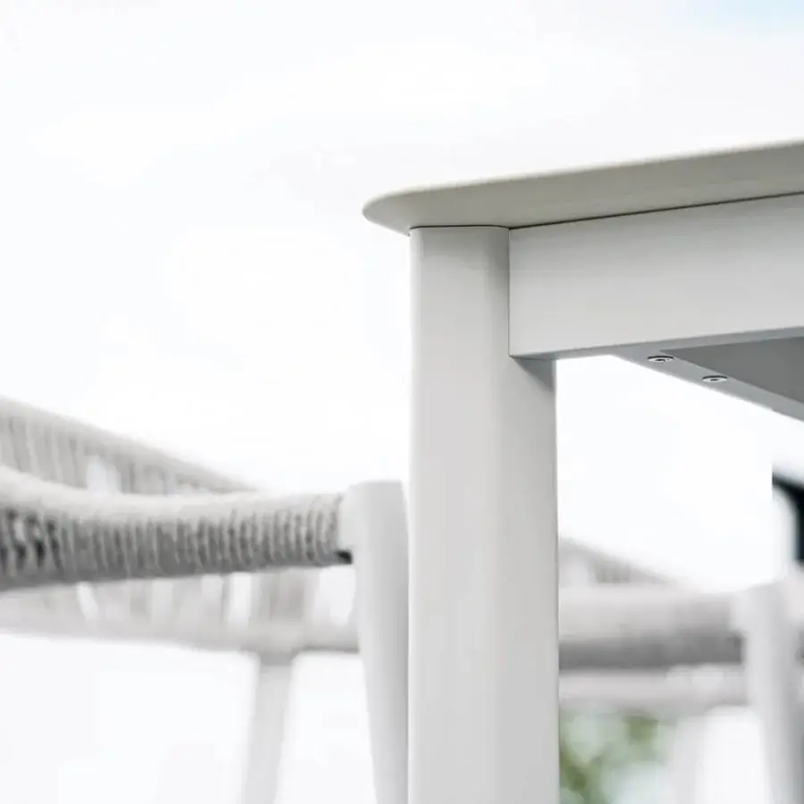 Innovative Varaschin System table with a bright white HPL top and powder-coated aluminum structure crafted in Italy