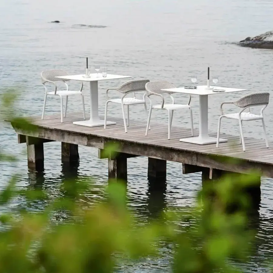 Distinguished Varaschin Plinto Bistrot table with geometric silhouette and pristine white HPL or Ceramic top built with aluminum base