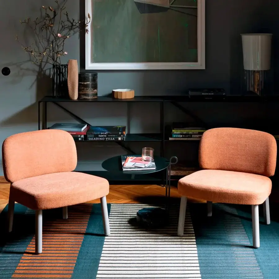 Lavish Bross Aretha lounge chair with textured matte orange fabric and smooth matte wood legs