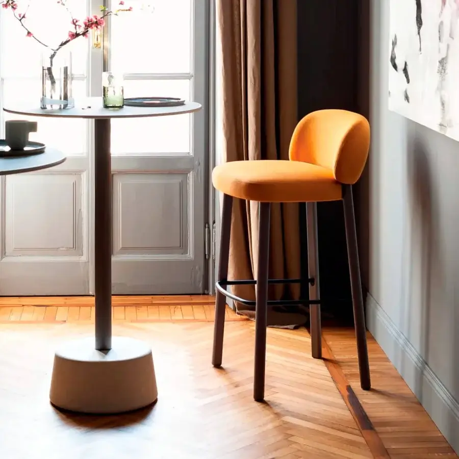 Distinguished Bross Aretha stool with vibrant orange premium fabric, dark brown tapered wooden legs and black metal footrest