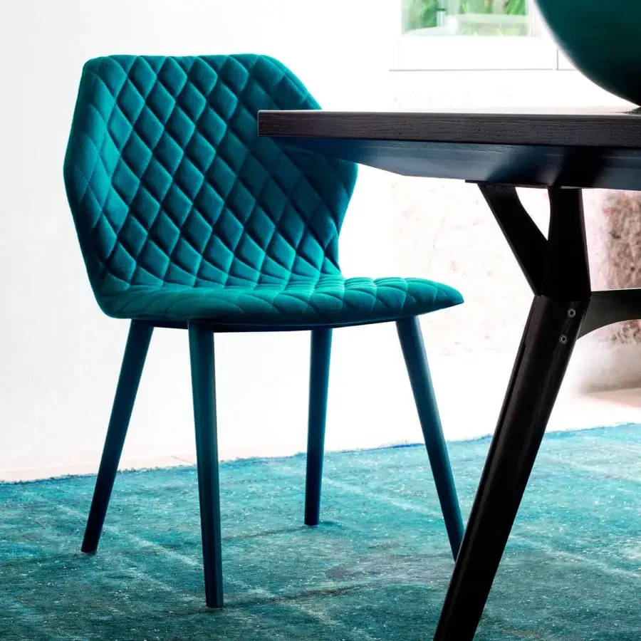 Captivating Bross Ava chair with teal fully upholstered shell and quilted diamond pattern built with lacquered metal legs