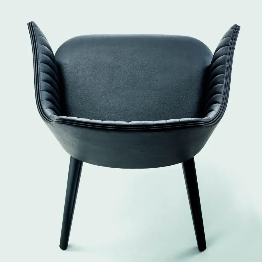 Exclusive Bross Break armchair fully upholstered in dark gray or black leather with quilted front and lacquered wood legs