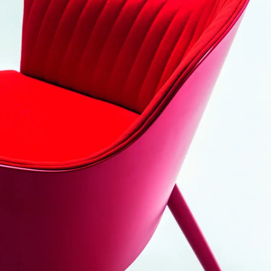 Distinguished Bross Break armchair fully upholstered in red textured fabric with glossy reddish-pink lacquer legs