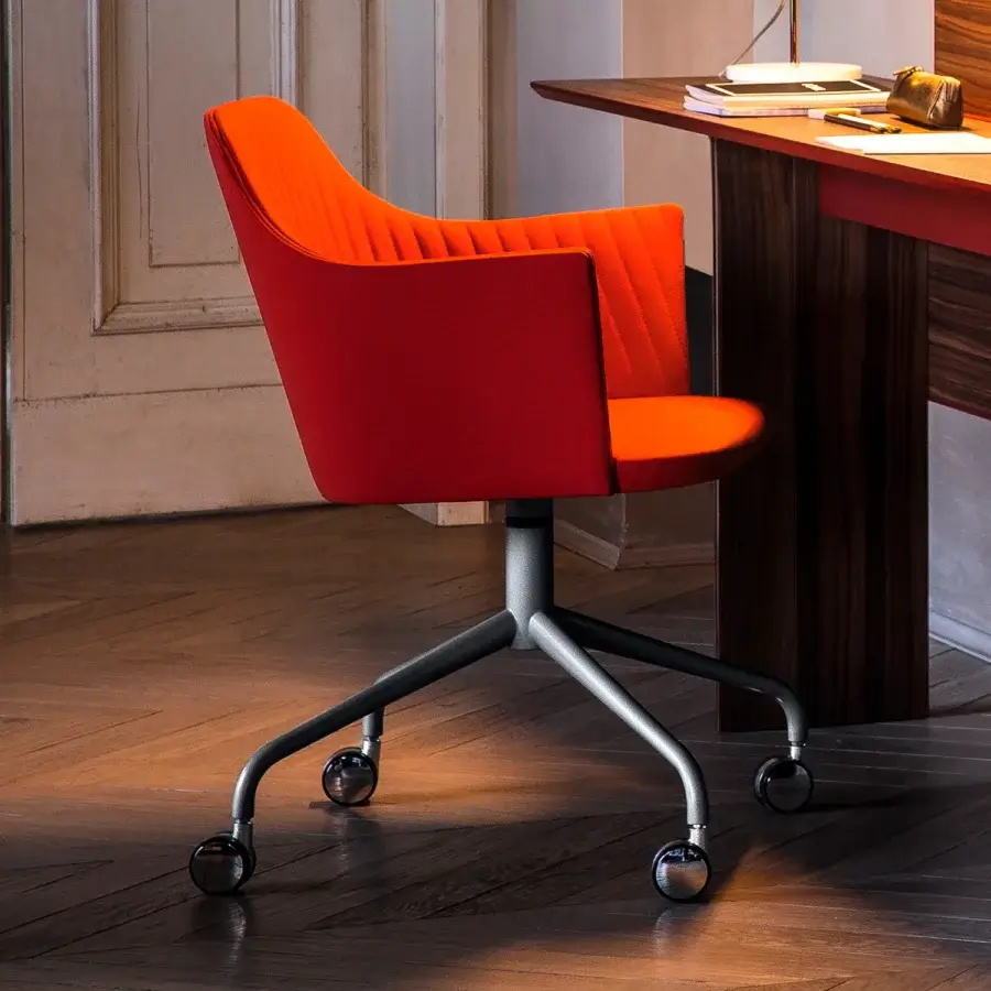 Superior Bross Break armchair upholstered in bright orange textile with quilted detailing and matte grey metal base