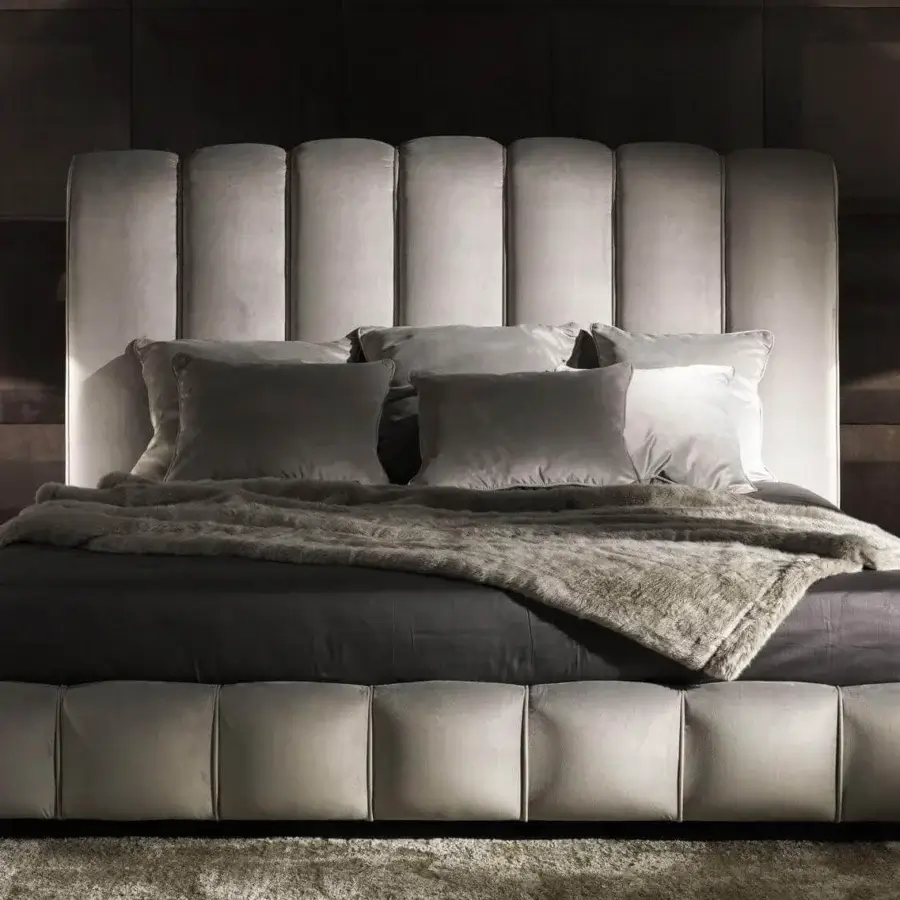 Exclusive DV Home Collection Byron bed with channeled headboard and footboard upholstered in light grayish-beige fabric or leather