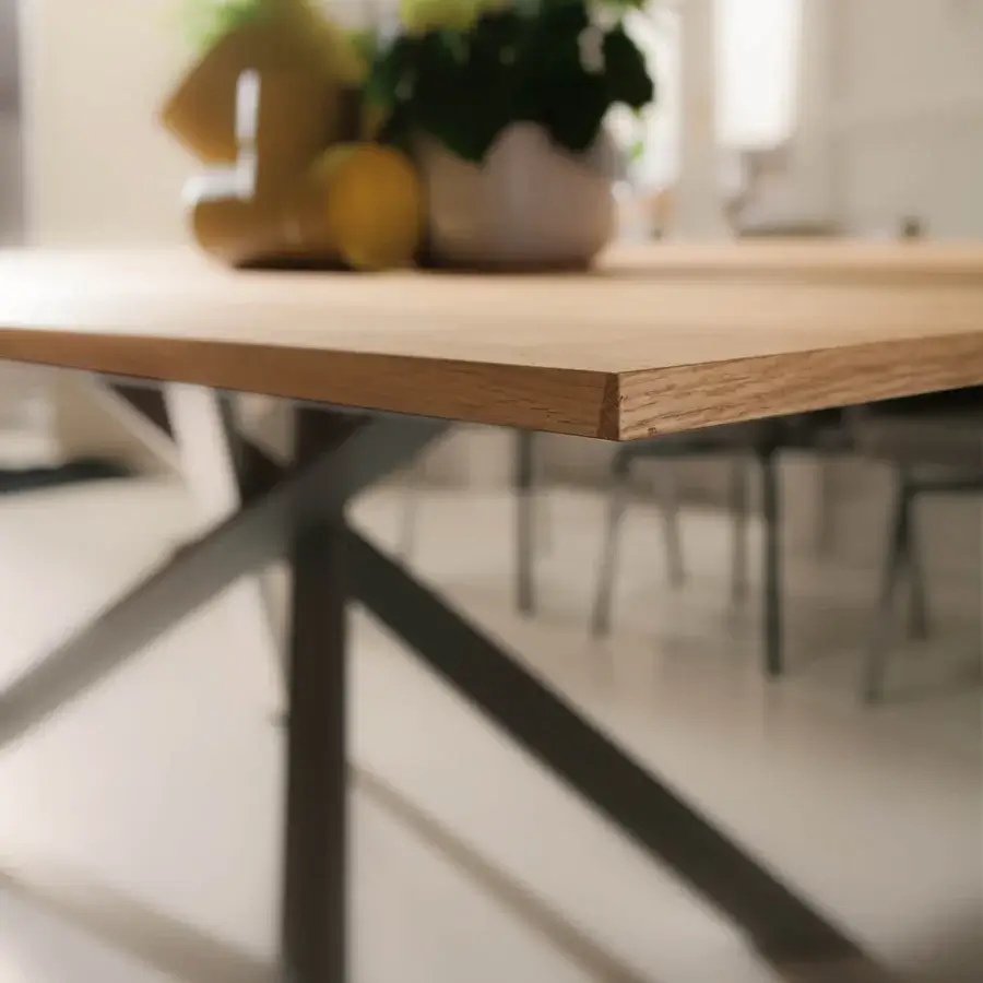 Superior Ozzio Italia 4x4 table with light brown wood-like top and dark gray metal X base crafted with a matte finish