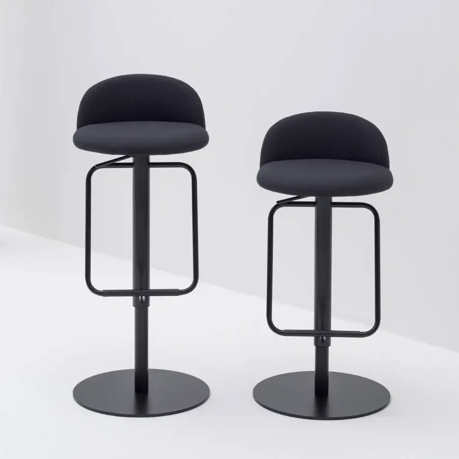 Superior Bross Cosmo stool with dark textile upholstery and matte black lacquered metal base and footrest