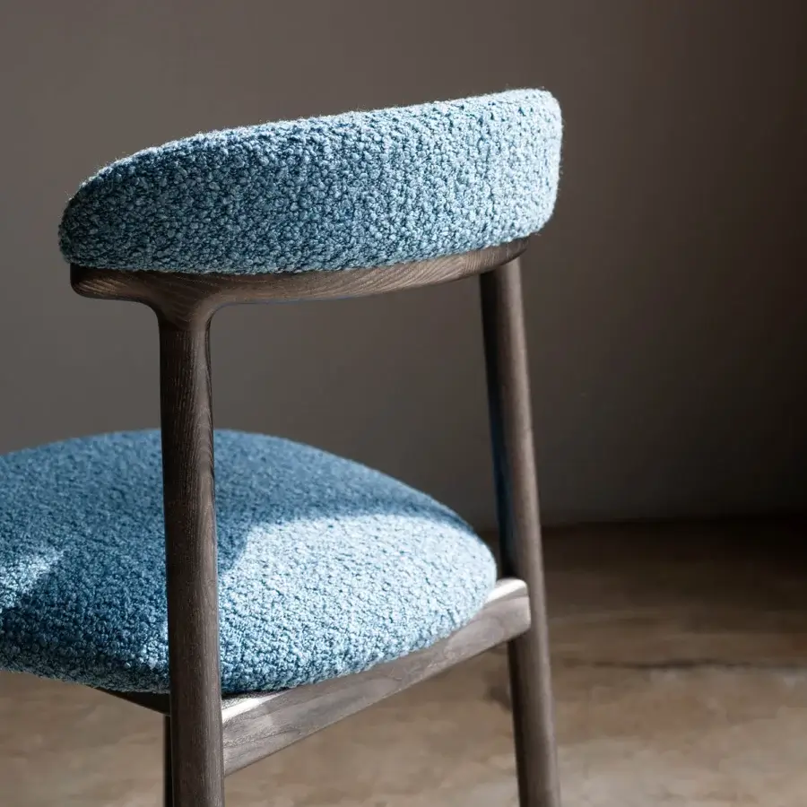 Distinguished Bross Lindy chair with light blue fabric upholstery and elegant wood frame, crafted in Italy